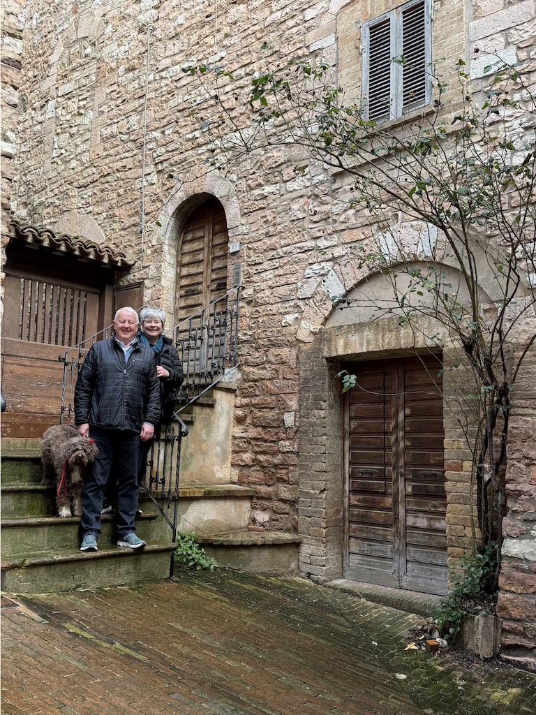 John and Wendy standing in front of their Spello home.